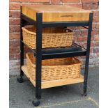 A MODERN SQUARE BUTCHERS BLOCK, raised on metal frame with wicker storage baskets, W 56 cm, D 53 cm,