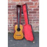 AN ANTIQUE VICTORIAN ACOUSTIC GUITAR IN FITTED WOODEN CARRY CASE, with curved frets and one piece