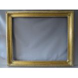 A 19TH CENTURY DECORATIVE GOLD FRAME WITH CORNER EMBELLISHMENTS, having egg and dart design to outer