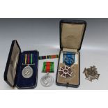 A CASED ROMANIAN ORDER OF THE CROWN MEDAL, together with a WWII defence medal and a boxed QEII civil