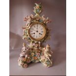 A LARGE CONTINENTAL PORCELAIN MANTEL CLOCK, the case adorned with two figures to the bottom with a