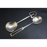 A PAIR OF ARTS AND CRAFTS STYLE SPOONS - BIRMINGHAM 2011, with a hand planished finish, approx