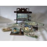 A COLLECTION OF VINTAGE SHIPS IN BOTTLES, to include an example on stand (7)