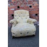 A VINTAGE 'HOWARD & SONS STYLE' UPHOLSTERED ARMCHAIR, A/F