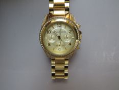 A MICHAEL KORS GOLDTONE WRISTWATCH, the face having crystal set border and further embellishment