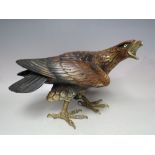 AN ITALIAN DECORATIVE FIGURE OF AN EAGLE, with inset glass eyes, brass beak and feet embellishment,