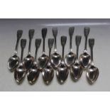 A MATCHED SET OF TWELVE HALLMARKED SILVER FIDDLE AND THREAD TABLE SPOONS, various dates and