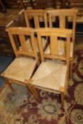 A SET OF FOUR WICKER SEAT SCHOOL STYLE CHAIRS