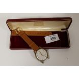 A GARRARD WRISTWATCH, POSSIBLY 9 CT GOLD, ON A REPLACEMENT STRAP, IN A GARRARD AND CO BOX