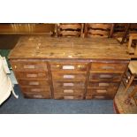 A VINTAGE BANK OF THREE DRAWERS WITH A LATER PLANK TOP H-76 CM W-149 CM