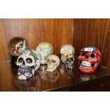 SIX ASSORTED DECORATIVE SKULLS TOGETHER WITH A NOVELTY BLACK SNOW MUSICAL SNOW GLOBE WITH SKELETON