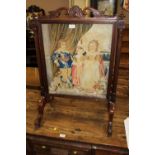 AN EARLY VICTORIAN MAHOGANY AND TAPESTRY EMBROIDERED FIRE SCREEN, the embroidered panel depicting