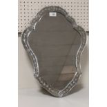 A MODERN DECORATIVE SHAPED WALL MIRROR