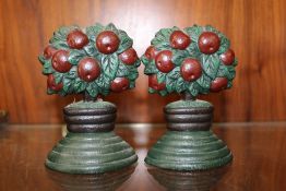 A PAIR OF SMALL CAST METAL DOOR STOPS, IN THE FORM OF FRUIT TREES