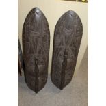A PAIR OF AFRICAN STYLE TRIBAL SHIELDS WITH BIRD DESIGN HANDLES