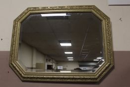 A MODERN GILT WALL MIRROR