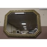 A MODERN GILT WALL MIRROR