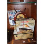 A TITANIC INTEREST REPRODUCTION SHIPS WHEEL, TWO TRAVEL CASES AND A SIGN