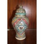 A MOROCCAN STYLE LIDDED JAR WITH METAL OVERLAY