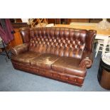 A VINTAGE BROWN LEATHER WINGBACK THREE SEATER SETTEE A/F