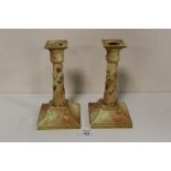 A PAIR OF ROYAL WORCESTER BLUSH IVORY CANDLESTICKS, decorated with hand painted floral and raised