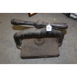 A VINTAGE CAST IRON BOOK PRESS, width of base 25 cm, length of base 30 cm, height when closed 30 cm