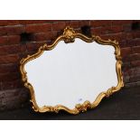 A MODERN SHAPED GILT WALL MIRROR W-106 CM