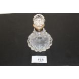 A HALLMARKED SILVER COLLARED CUT GLASS SCENT BOTTLE