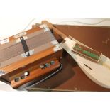 A MODERN ARIETTE ACCORDION TOGETHER WITH A GUITAR SHAPED STORAGE BOX AND A HARMONICA