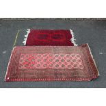 TWO EARLY 20TH CENTURY RED / BLACK WOOLLEN RUGS - LARGEST 166 X 116 CM (2)