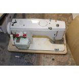 A CASED NEW HOME ELECTRIC SEWING MACHINE