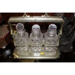 A VINTAGE SILVER PLATED THREE BOTTLE TANTALUS