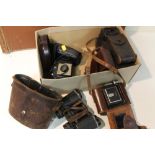 A BOX OF VINTAGE CAMERAS TO INCLUDE A HOUGHTONS LTD ENSIGNETTE NO.2, IKONTA, KODAK ETC TOGETHER WITH