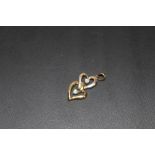 A 9 CARAT GOLD AND DIAMOND DOUBLE HEART PENDANT, APPROX WEIGHT 1.4G