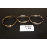 A BOX OF SILVER AND ROLLED GOLD CHRISTENING BANGLES