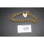 A HALLMARKED 9 CARAT GOLD BRACELET WITH HEART LOCK, APPROX WEIGHT 13.5G
