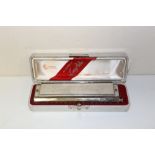 A BOXED LARRY ADLER PROFESSIONAL 16 HOHNER CHROMATIC HARMONICA