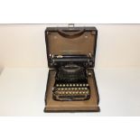 A VINTAGE CASED CORONA FOLDING TYPEWRITER