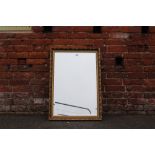 A MODERN GILT RECTANGULAR MIRROR 85 X 59 CM