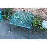 A PAINTED GREEN METAL GARDEN BENCH