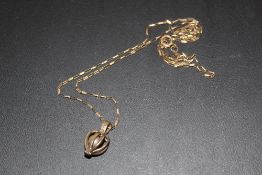A CAGED PEARL PENDANT ON 9 CT GOLD CHAIN, APPROX WEIGHT 4.7 G