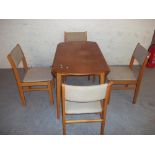 A RETRO TEAK DROPLEAF DINING TABLE AND FOUR CHAIRS
