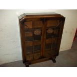 AN OAK GLAZED TWO DOOR BOOKCASE