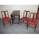 AN ANTIQUE OAK BARLEY TWIST DROPLEAF DINING TABLE WITH THREE MATCHING CHAIRS
