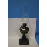 AN BRASS ANTIQUE OIL LAMP WITH CAST IRON BASE