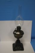 AN BRASS ANTIQUE OIL LAMP WITH CAST IRON BASE