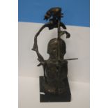 A METAL MODERN ART FIGURE OF A LADY PLAYING A CELLO ON WOODEN PLINTH