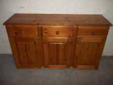 A THREE DRAWER, THREE DOOR SOLID PINE DRESSER SIDEBOARD