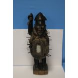 A KONGO POWER FIGURE BRANDISHING AN IRON SPEAR WITH INSET GLASS EYES AND A PANEL TO HIS ABDOMEN, H