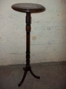 AN ANTIQUE HARDWOOD TORCHERE PLANT STAND